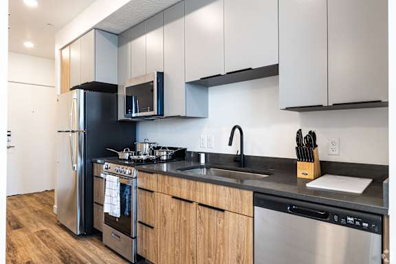 A modern kitchen with wooden cabinets and stainless steel appliances.