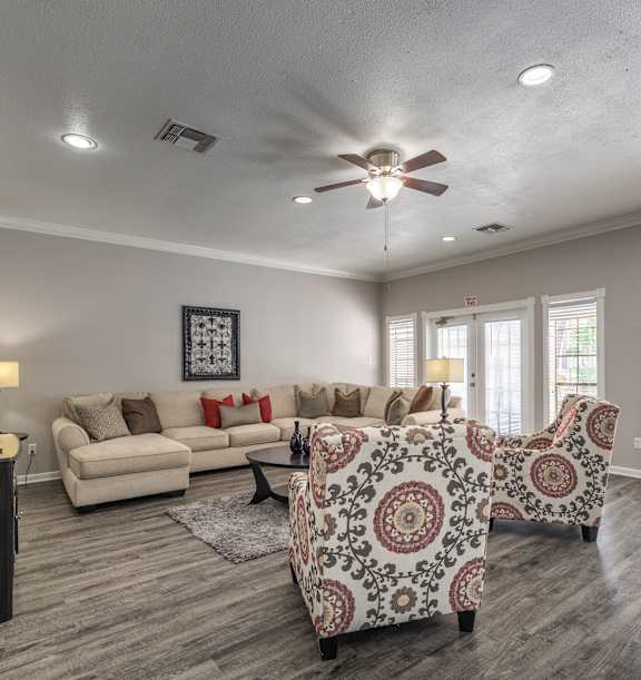 A living room with a patterned sofa and a television.