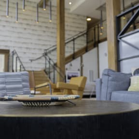 a coffee table with a tray on it in a living room with a staircase in the background at Preston Ridge, Hickory, NC