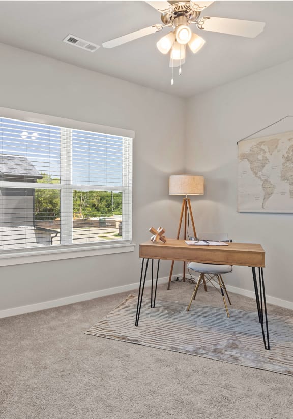 an office with a desk and a window and a ceiling fan at Hillcrest Village, Springdale, AR