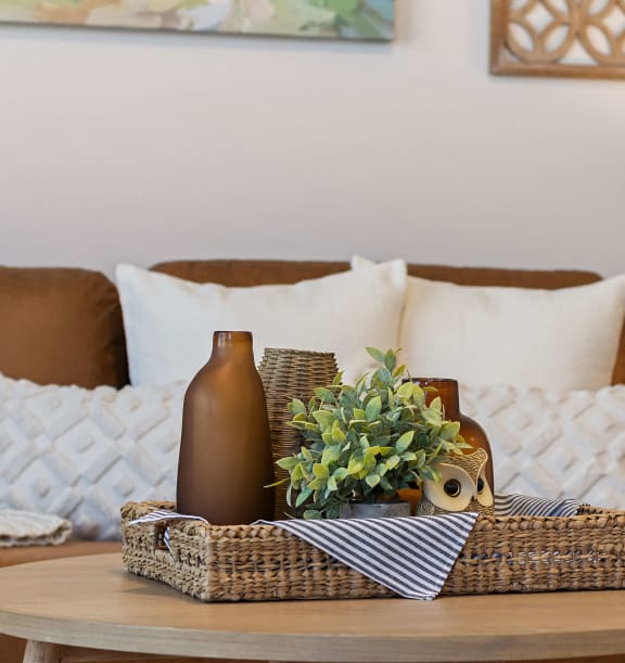 a living room with a brown couch and a coffee table at Hillcrest Village, Springdale