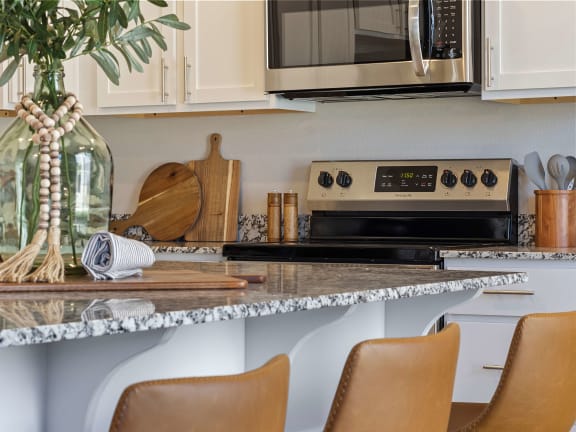 a kitchen with a marble counter top and a microwaveat Hillcrest Village, Springdale, AR 72762