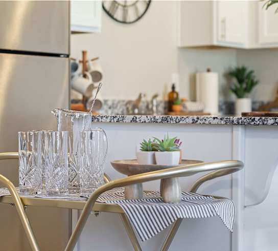 a small kitchen with a table and chairs and a refrigeratorat Hillcrest Village, Springdale Arkansas
