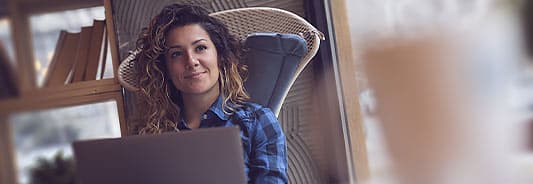 woman sitting in chair with laptop