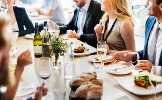 A group of people are enjoying a meal together at a restaurant.