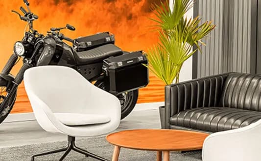 a living room with a motorcycle and a chair and a table