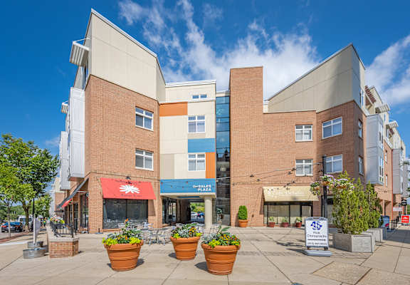 A building with a red awning and a blue sign in front of it.