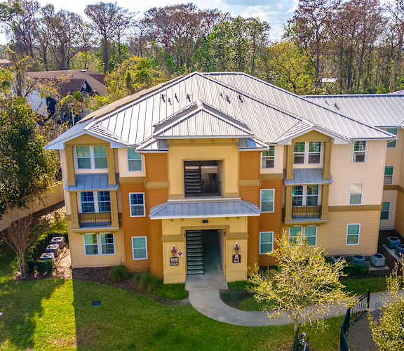 an aerial view of a large apartment building with a metal roof