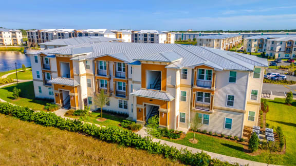 an aerial view of an apartment complex with a river in the background
