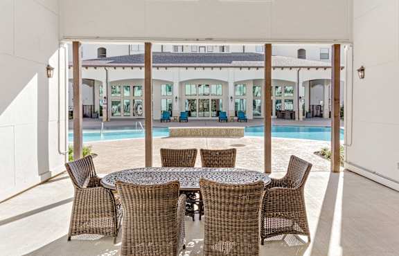 Enclosed seating area with pool view