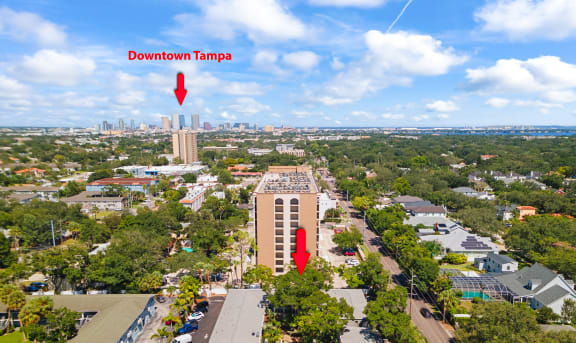 an aerial view of the building with two red arrows pointing to it