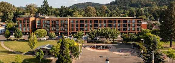 A large building with a circular courtyard in front of it.