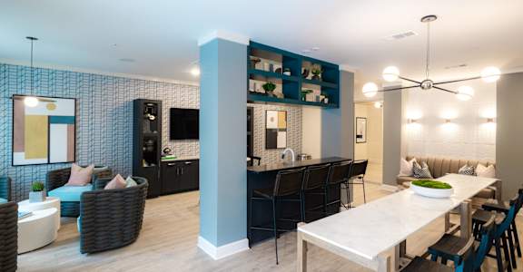 A modern living room with a dining area and kitchen in the background.