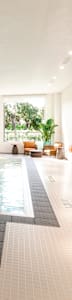 A large indoor swimming pool with a glass divider.