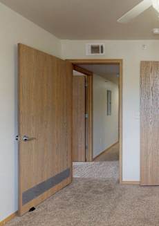 a bedroom with two closets and a ceiling fan