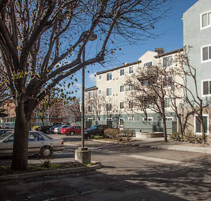 the view of an apartment building from the street