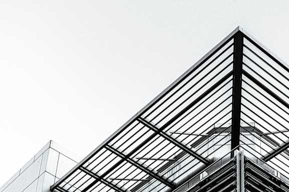 A modern building with a glass roof structure.