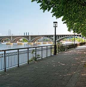 A bridge over a river with a walkway on the side.