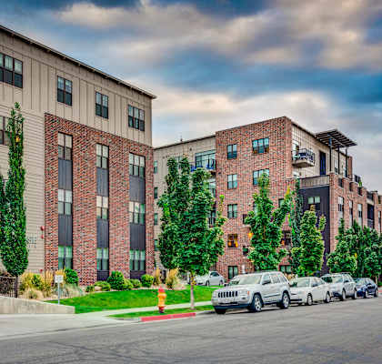 a city street with cars parked in front of two apartment buildings at Sugar House Apartments By Urbana, Salt Lake City, UT, 84105