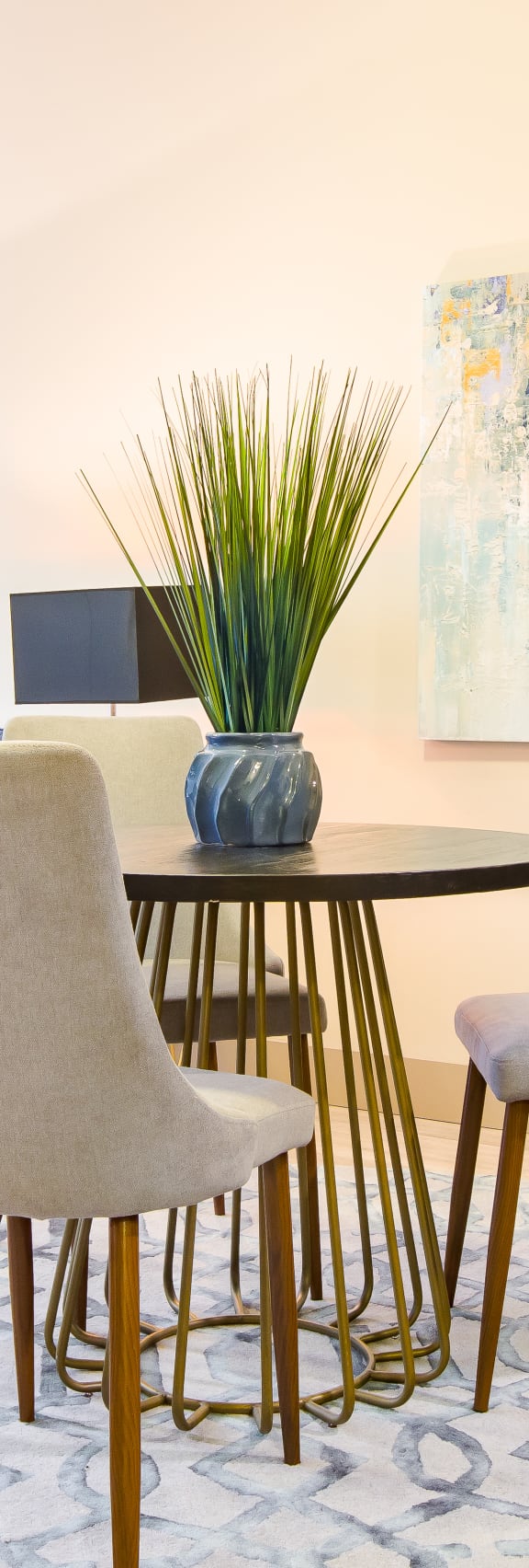 A modern dining room with a blue sofa and two chairs at Sugar House Apartments By Urbana, Salt Lake City, UT, 84105
