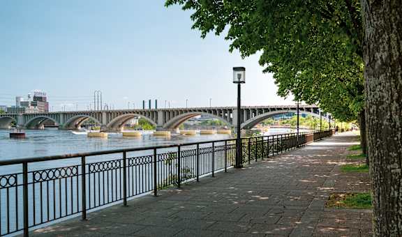 A bridge over a river with a walkway on the side.