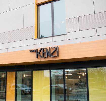 The KENZ logo is on a building.