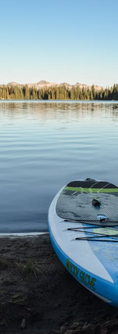 a kayak on the shore of a lake
