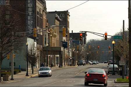 A city street with cars and traffic lights.