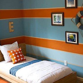 a bedroom with a bed and pictures on the wall