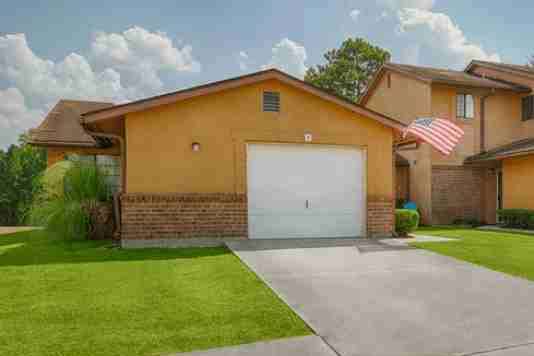 A house with a garage and an American flag hanging on the wall.
