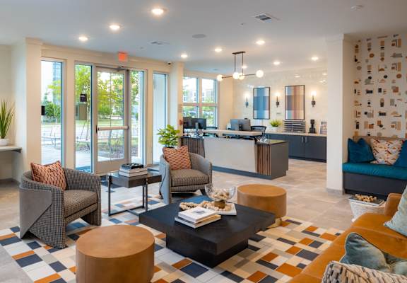 A modern living room with a large window at Hudson at Renaissance Apartments, North Carolina