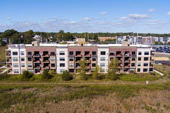 A large apartment complex with multiple buildings and balconies.