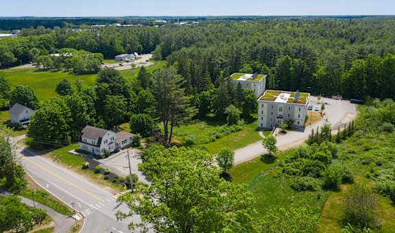 arial view of the house with green roof