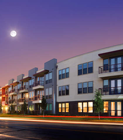 A modern apartment building with a full moon in the sky. at Matilda at Lower Greenville, Texas