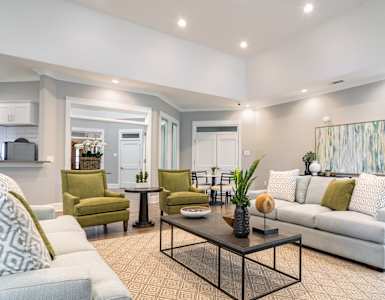 a living room with couches and chairs and a table