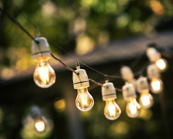 A string of light bulbs is hanging from a wire.