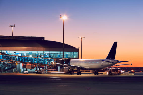 a fighter jet sitting on top of an airport runway