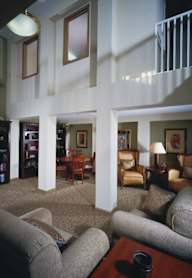 A living room with a couch, chairs, and a coffee table.