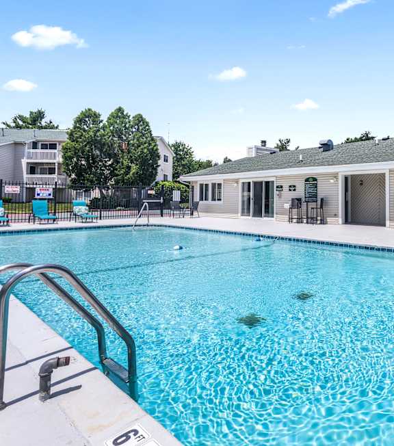 A black fence surrounds a small pool.