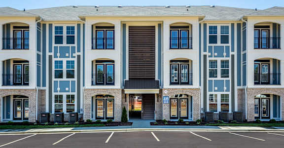 a large apartment building with a parking lot
