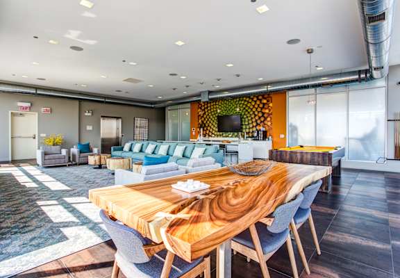 a living room and dining room with a wooden table