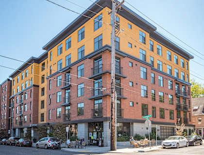 A multi-story building with a mix of orange and red facades.