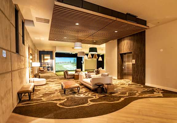 A modern living room with a large rug and a flat screen TV.