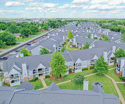The arial view of the light blue residential apartment homes and the surrounding neighborhood at Villas at Countryside Apartment Homes