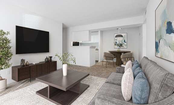 A modern living room with a grey couch and a wooden coffee table.