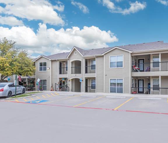 apartment complex with cars parked at Crosspoint Oaks at Boerne, Boerne, TX 78006