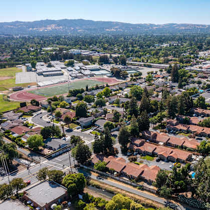 an aerial view with houses and trees of Oak Grove Terrace apartments in 94518, Oak Grove Rd, CA