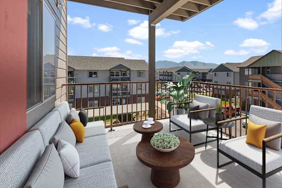 a balcony with couches and chairs and a coffee table