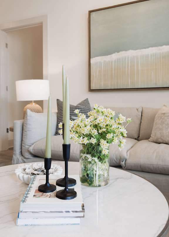 a rendering of a living room with a kitchen in the background at Saltaire Apartment Homes, Santa Rosa Beach, FL