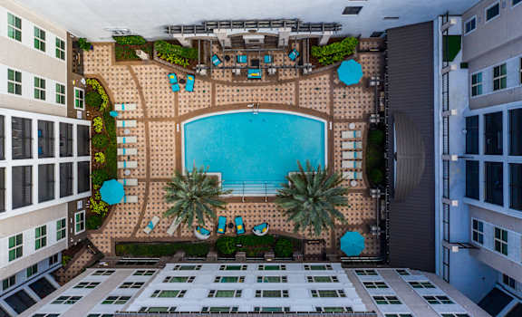 arial view of a swimming pool in between two buildings at The Rialto, Orlando, FL